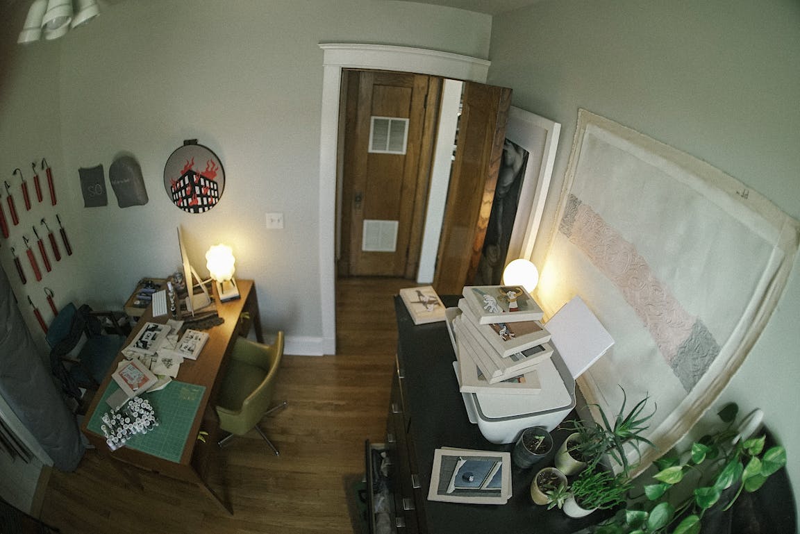 An overhead view shows a cozy artist's studio.